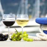 Wineglasses and grapes on the pier