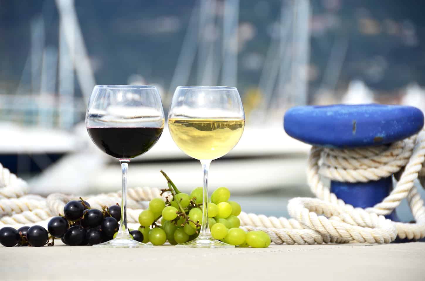 Wineglasses and grapes on the pier
